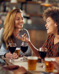 two women enjoying drinks at The Journeyman Craft Bar and Kitchen